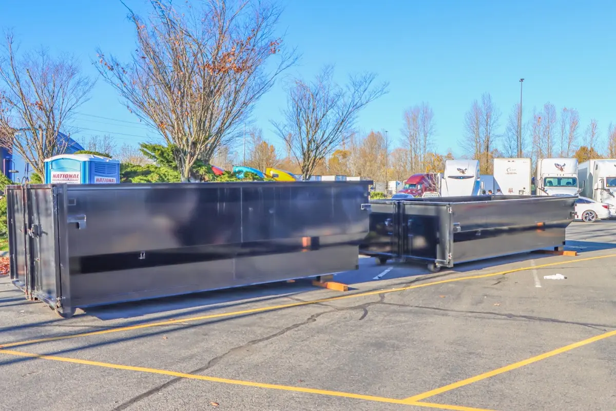 Professional dumpster rental service with roll-off container on residential driveway in Wilna